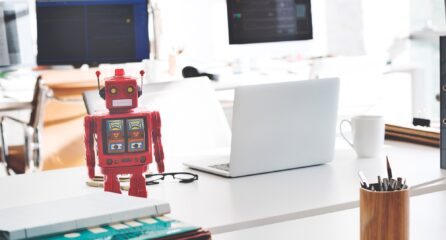 robot sat on computer desk